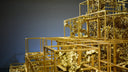 Golden metallic cube structure with intricate branching crystalline formations showcasing art gold for fine jewelry use
