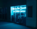 A glowing blue neon sign for william penn jeweler and watchmakers featured in art gold jewelry local reviews