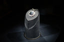 A stunning blue diamond pendant with a halo of smaller diamonds on dark gray velvet showcases fine jewelry and art gold.