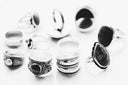 Silver-toned fine jewelry rings with intricate designs and dark stone accents featured in the story of jewelers and gold jewelry