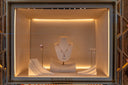 A bvlgari 18k gold necklace with sparkling diamonds and a central pendant displayed on a white mannequin bust for heirloom jewelry investment.