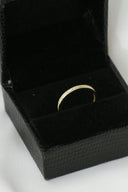 A black box with a gold ring inside of it