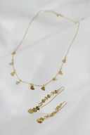 A necklace and earring set on a white sheet