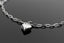 a silver heart necklace on a black surface