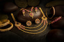 Timeless golden floral necklace with filigree and pink green gems