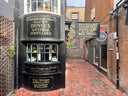 Antique jewellers shop on a narrow brick street.