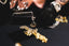 a close up of a person's hands with gold jewelry