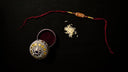 Elegant gold beaded round box with silver and red string in art gold jewelry