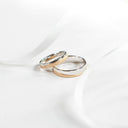 Two elegant custom gold wedding bands featuring 18k gold and silver accents in a stylist’s perspective on gold jewelry.