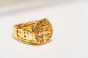 Gold saint benedict ring in custom gold jewelry featuring intricate engraved cross and inscriptions on circular face