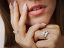 A sparkling diamond ring with clear stones set in a sleek silver band for 18k gold jewelry care tips.