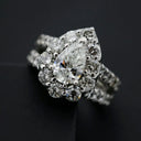 A sparkling pear-shaped diamond ring set in platinum with round diamonds showcasing fine jewelry trends.