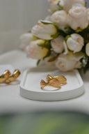 Gold-toned intricately twisted men’s gold ring with ribbed texture ideal for 18k gold jewelry and engagement rings.