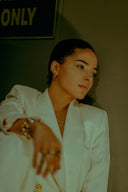 White blazer with gold buttons and subtle sheen complementing fine jewelry and 18k gold maintenance tips
