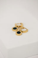 Gold hoop earrings with black accents in art gold jewelry