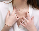 A delicate rose gold necklace with a teardrop pendant and diamonds layered over a fine 18k gold chain for gold jewelry care