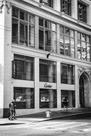 Cartier storefront with elegant stone facade and display windows showcasing fine gold jewelry and art gold jewelry designs
