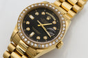 Gold rolex day-date watch with black dial diamond bezel and hour markers illustrating art gold jewelry purity.