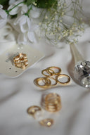 Gold geometric ring with clear stones on white card showcasing fine jewelry in 18k gold for luxury jewelry guide