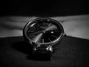 A sleek black raga titan watch with polished metallic case and minimalist dial showcased in fine jewelry craftsmanship.