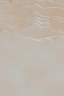 a bird flying over a sandy beach next to the ocean