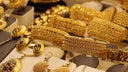 Display of 18k gold chain, 14k gold rings, and art gold jewelry