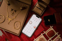 White smartphone displaying a calendar app in an article about unlocking financing options for art gold jewelry at everett store