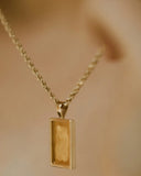 Rectangular gold jewelry pendant featuring textured amber resin inlay crafted in luxurious 18k gold art gold design