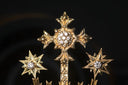 Gold jewelry golden cross brooch with intricate filigree and diamond accents featured in crown jewels collection