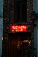 a red neon sign that is on the side of a building