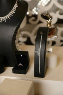 A sleek black leather bracelet box showcasing a sparkling diamond-encrusted fine jewelry piece for secure art gold storage