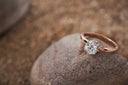A rose gold solitaire engagement ring with round-cut diamond on slender band featured by everett jewelry store.