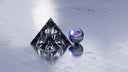 Cursed crystal pyramid and iridescent sphere in luxury jewelry lore