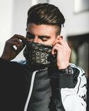 Black face mask with repeating cara lettering pattern complements van cleef and harry winston engagement ring styles