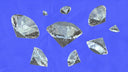 Faceted clear gemstones with reflective surfaces on blue background symbolize elegance in fine jewelry and art gold jewelry.