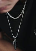 a woman wearing a black shirt and a silver necklace