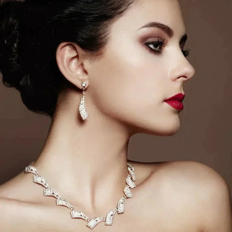 Woman in gold mini hoops earrings, 18k yellow gold, red lips, dark hair