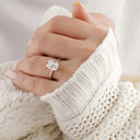Diamond engagement ring on white knit sweater sleeve, eternal love 18k