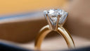 Diamond engagement ring with a gold band and solitaire setting.