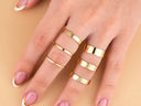 Hand adorned with gold rings.