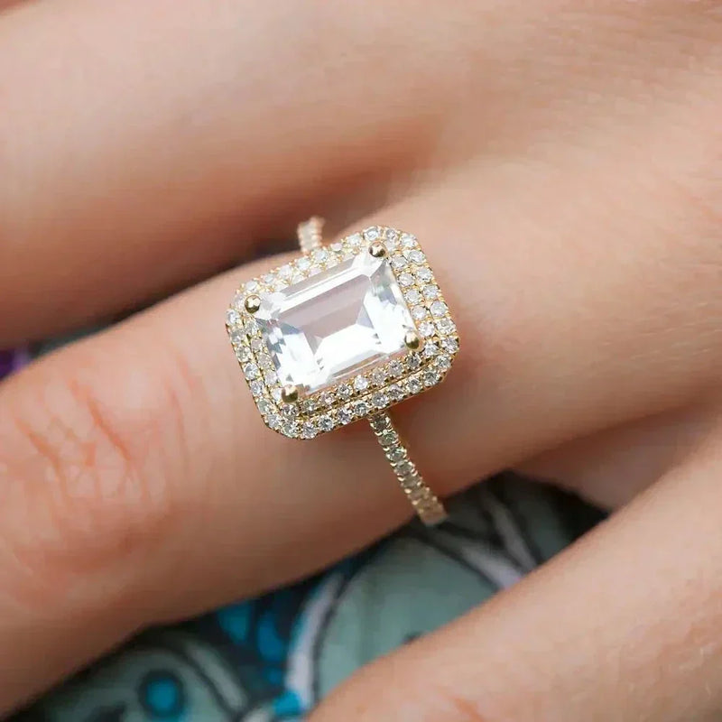 Diamond emerald-cut halo engagement ring in 18k 3-tone gold