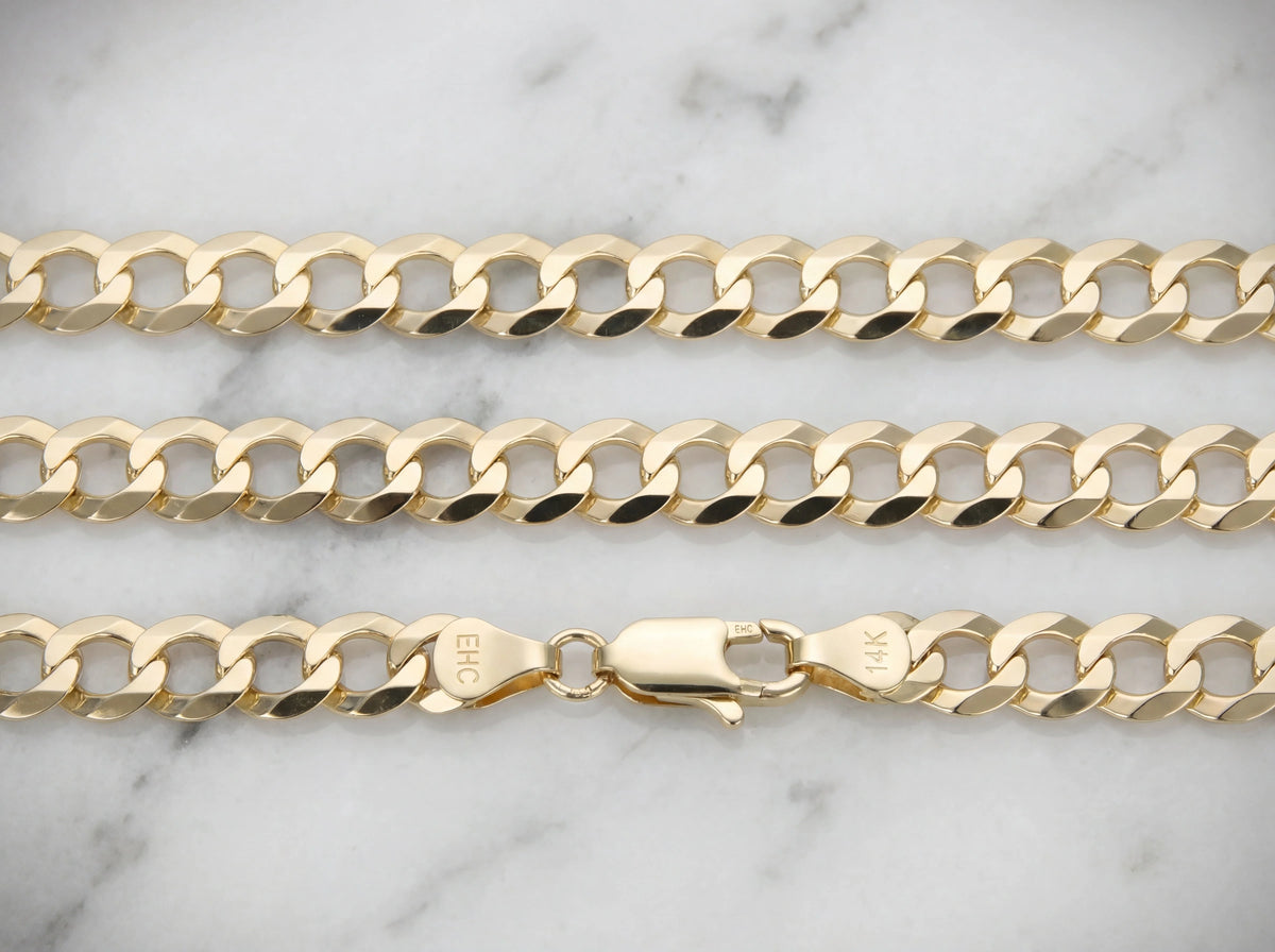 14K gold Cuban link chain on marble surface showing clasp detail