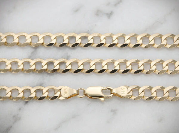 14K gold Cuban link chain on marble surface showing clasp detail