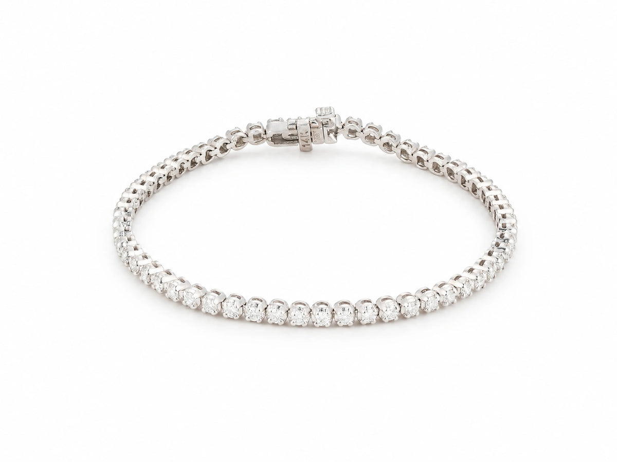 14K white gold tennis bracelet laid in an oval on white, one continuous row of round lab grown diamonds, box clasp at the top