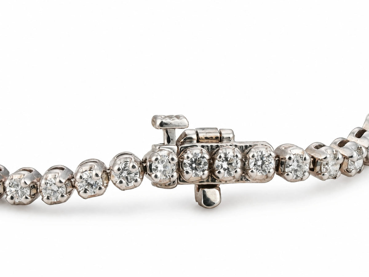 The white gold diamond tennis bracelet seen from the front, box clasp with its safety latch at the centre and the stone row running off both sides