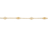 Close view of the alternating stations on the 14K yellow gold cable chain, a round diamond in a polished bezel beside a gold bead with a milgrain rim