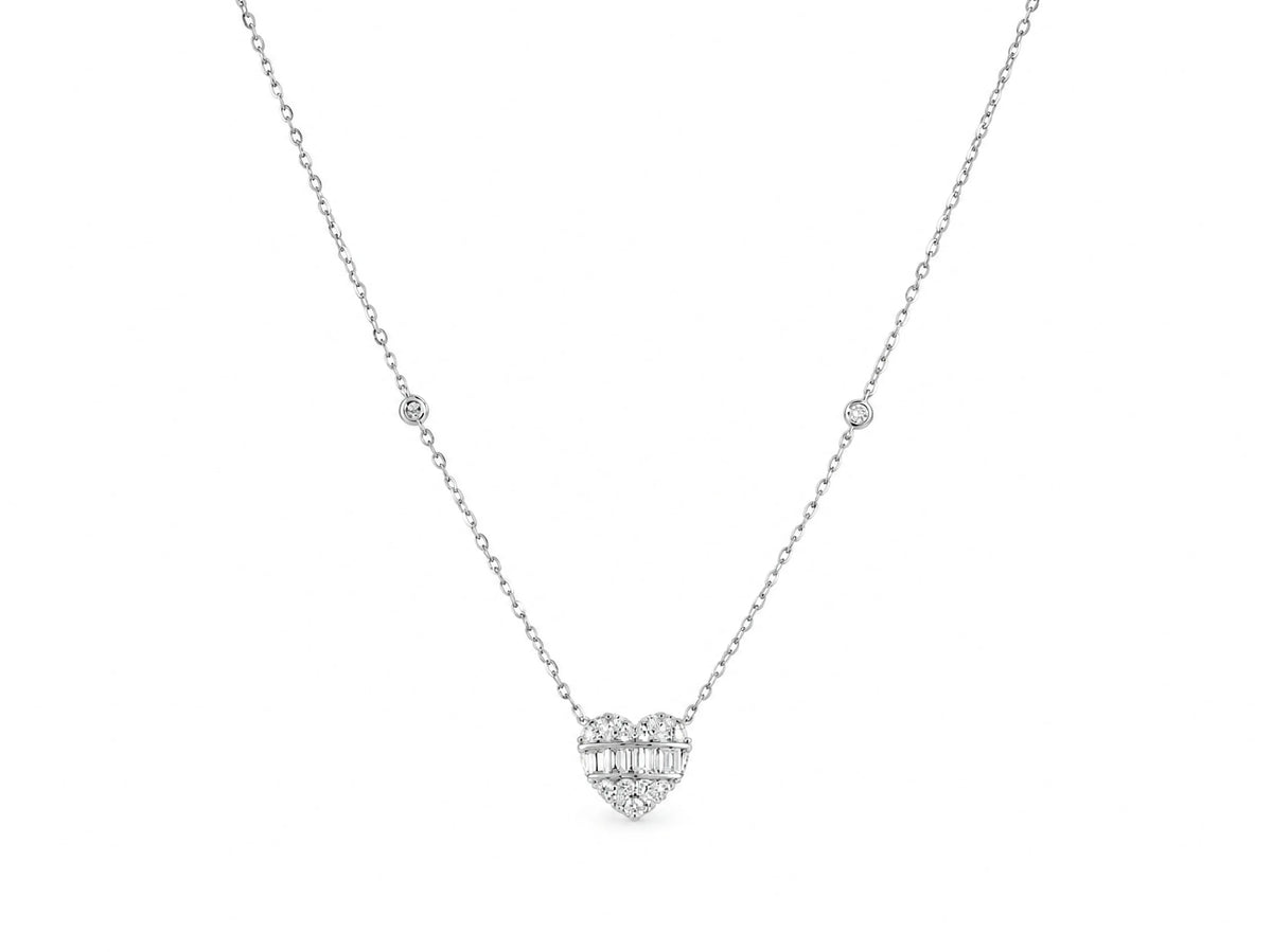 The same diamond heart necklace shown wider in the frame, the chain forming a V with a bezel-set diamond on each side and the heart at the lower point.