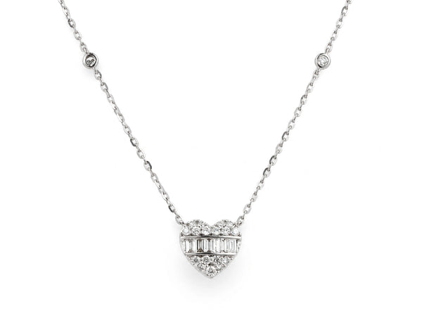 A 14K white gold diamond heart necklace laid out flat, its face crossed by a channel of baguette-cut diamonds, on a fine cable chain.