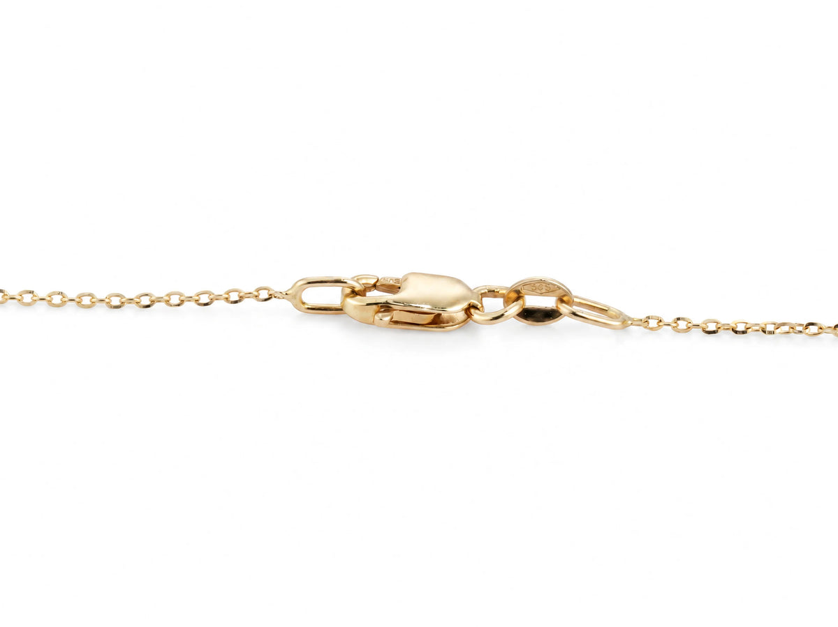 The lobster claw clasp of the clover necklace, closed on its ring, with the 585 gold mark stamped on the ring beside the clasp