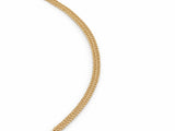 Close-up detail of the woven chevron link pattern on the gold chain necklace